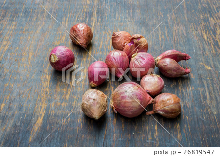 Red onion on rustic background. 26819547