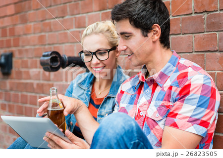 couple reading city guide before making tour  26823505