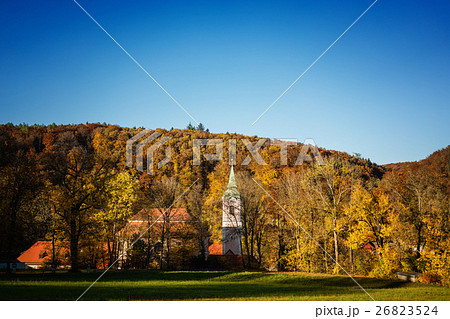 Little baroque church or chapel in colorful forest 26823524