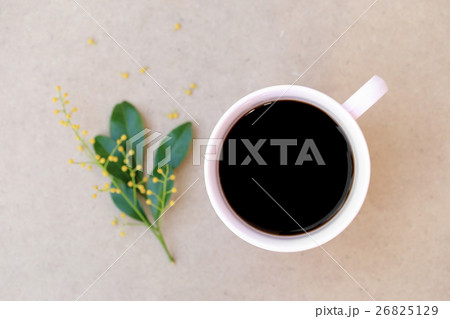 Cup of black coffee and leave on wood background. 26825129