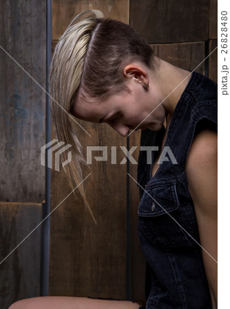 Blond woman with head down 26828480