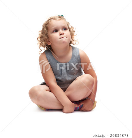Young little girl sitting over isolated white Young little girl sitting over isolated white 26834373