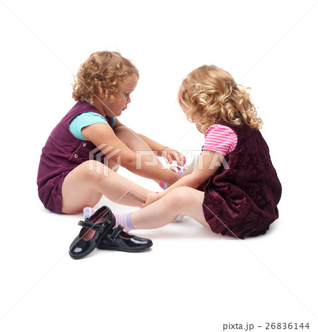 Couple of young little girls sitting over isolated 26836144