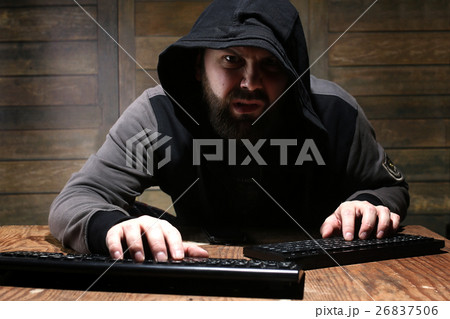 hacker in the black hood in a room hacker in the black hood in a room 26837506