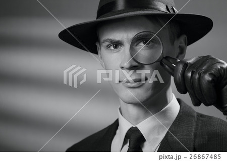 Handsome intelligent young detective in a hat Handsome intelligent young detective in a hat 26867485