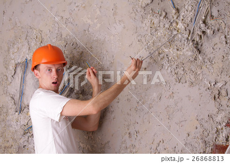 Surprised worker electric trying to fix the wires 26868813