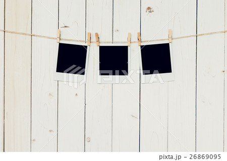 Three (3)blank photo frame hanging on white wood 26869095