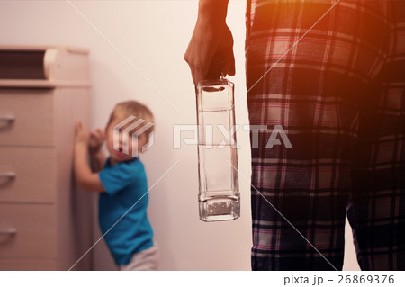 Drunk mother with bottle and frightened son Drunk mother with bottle and frightened son 26869376