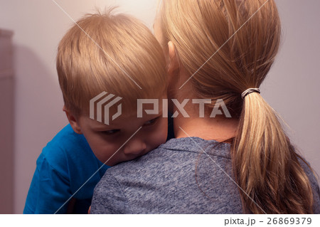 Young blonde woman comforting her little son 26869379