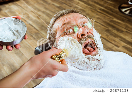 The senior man visiting hairstylist in barber shop 26871133