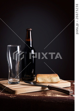 Glass and Bottle of dark beer with smoked cheese 26873238