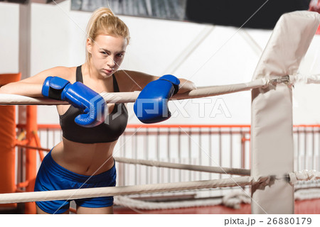 Fit determined boxer girl leaning on the ropes Fit determined boxer girl leaning on the ropes 26880179