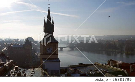 Spired clock tower against Vltava river in Prague 26881799