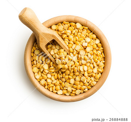 Yellow split peas in wooden bowl. 26884888