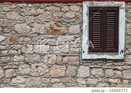 Textured wall with brown shutters Textured wall with brown shutters 26888771