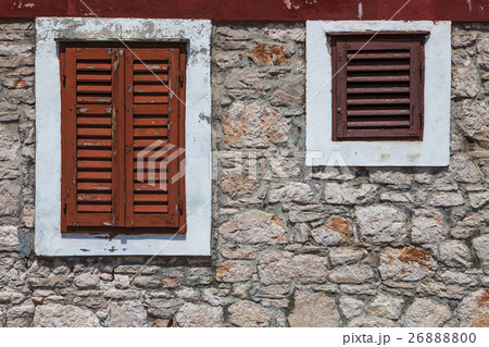 Textured wall with orange shutters 26888800
