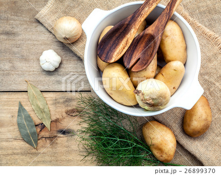 Fresh organic potatoes in hemp sack bag . 26899370