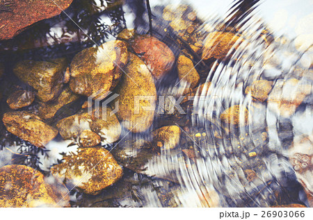 Ripples and reflections in a pebbly pond 26903066