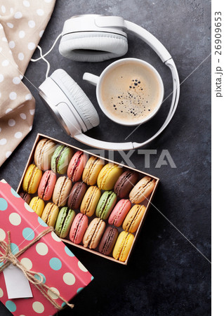 Colorful macaroons in a gift box and headphones 26909653