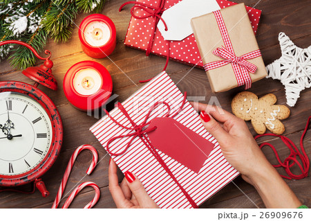 Female hands holding christmas gift Female hands holding christmas gift 26909676