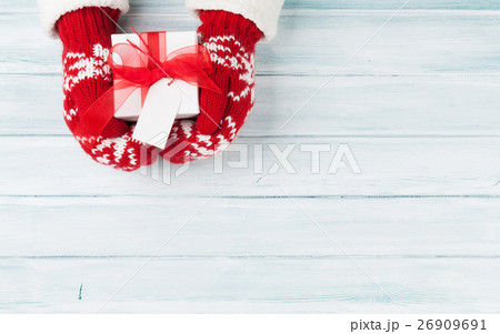 Female hands holding christmas gift Female hands holding christmas gift 26909691
