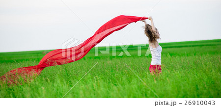 Young lady runing with tissue in green field 26910043
