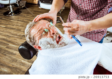 The senior man visiting hairstylist in barber shop 26913753