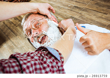 The senior man visiting hairstylist in barber shop 26913759