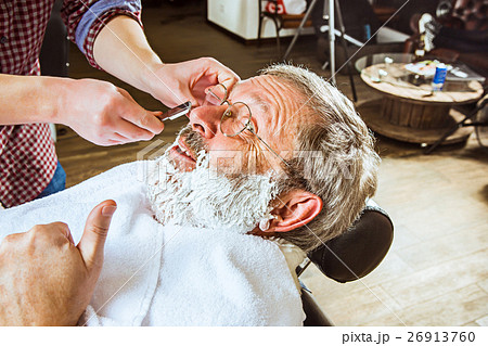 The senior man visiting hairstylist in barber shop 26913760