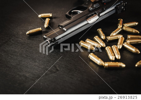 gun and bullets on the table 26913825