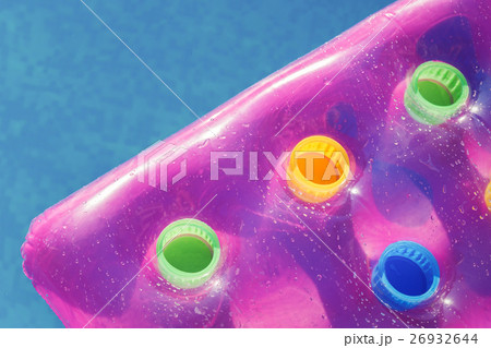 Pink air mattress in swimming pool 26932644