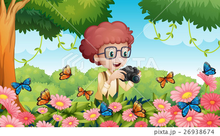 Boy taking picture of butterflies in garden 26938674