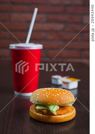 burger and paper cup coke or juice 26943440