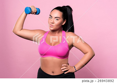 Pretty mulatto woman doing exercises with dumbbell 26943892