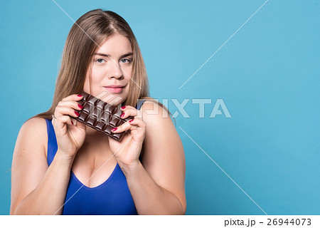 Pretty plump lady holding chocolate 26944073