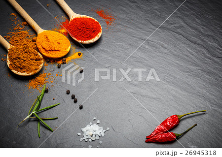 spices and herbs over black stone background spices and herbs over black stone background 26945318