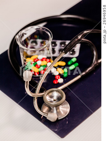medicine and medical instruments on table 26946958