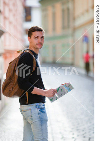 Man tourist with a city map and backpack in Europe Man tourist with a city map and backpack in Europe 26950655