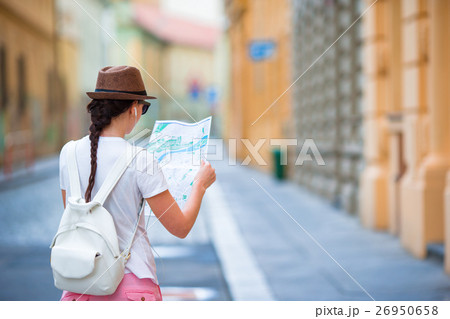 Happy young woman with a city map in city. Travel 26950658