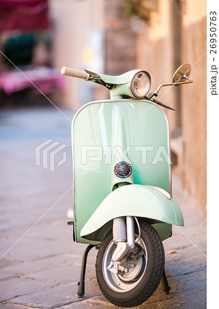 Light blue scooter on the street of the old city 26950763