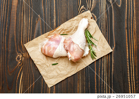 Raw chicken legs in baking dish on a wooden Raw chicken legs in baking dish on a wooden 26951057