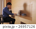 Young man working on a laptop computer at home 26957126