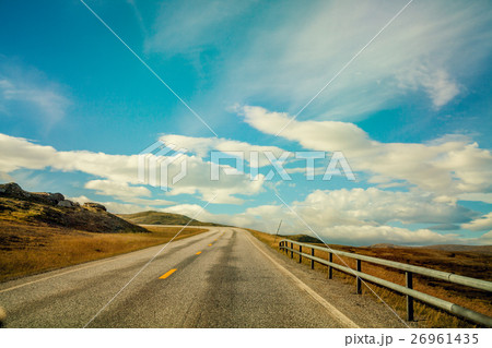 Driving a car on mountain road Driving a car on mountain road 26961435