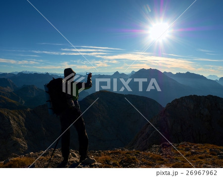 Hiker takes phone photo. Man on Alps mountain  26967962