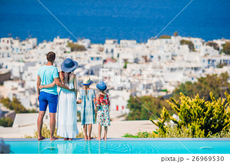Parents and kids on outdoor swimming pool 26969530