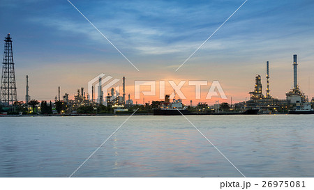 Oil refinery river front during sunrise Oil refinery river front during sunrise 26975081