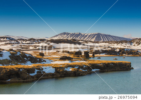 Volcano over the lake with clear blue sky 26975094