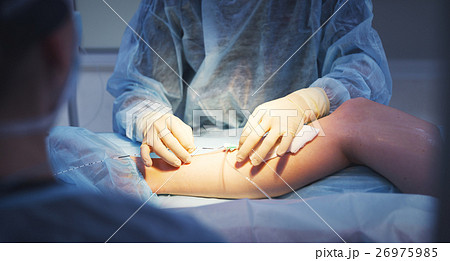 doctor and an assistant in operating for surgical doctor and an assistant in operating for surgical 26975985
