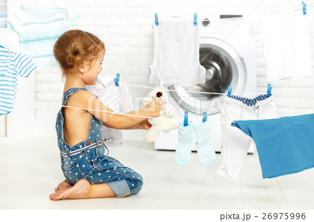 child fun happy little girl  to wash clothes  26975996