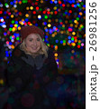 Beautiful young woman with christmas tree in the background 26981256
